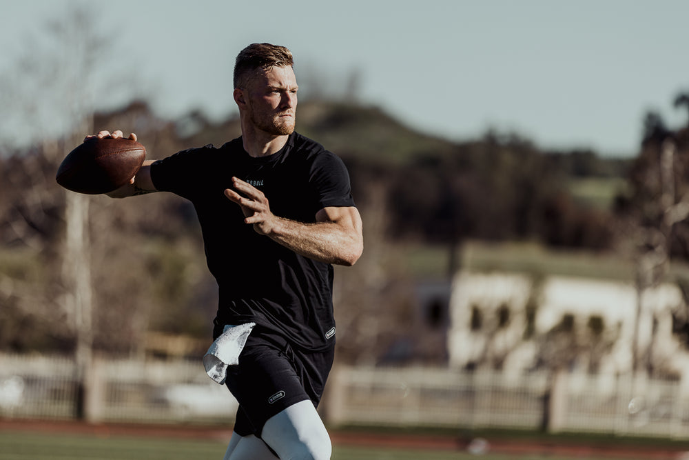 NFL Quarterback of the Tennessee Titans Will Levis throws a football wearing athletic clothes