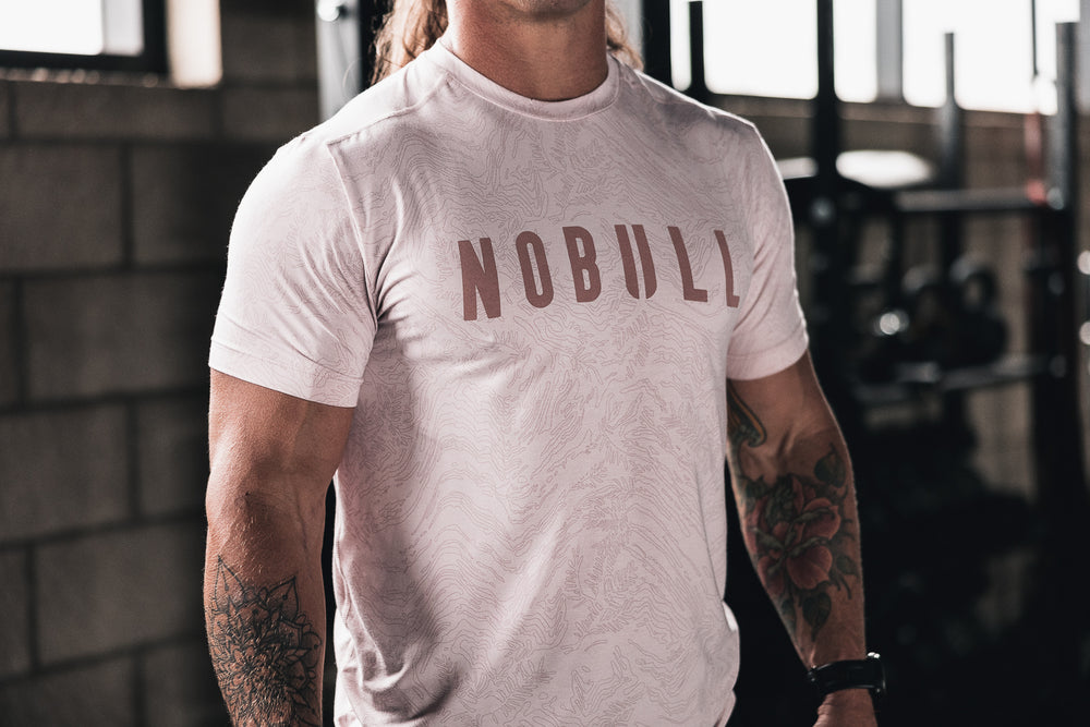 CrossFit athlete Sam Dancer wears a pink floral pattern athletic tee shirt before working out