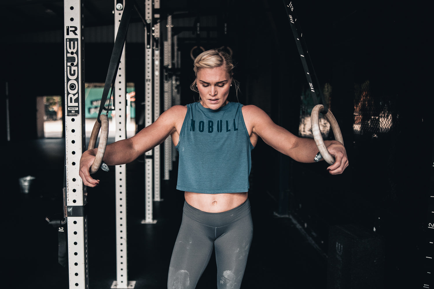 CrossFit athlete Katrin Davíðsdóttir is wearing athletic clothing while resting between sets of her workout